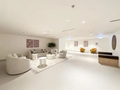 a large living room with couches and tables at Stylish 2BR in Forte 2 in Dubai