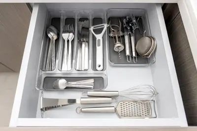 a drawer filled with utensils in a kitchen at Stylish 2BR in Forte 2 in Dubai