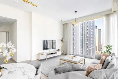 an apartment living room with a large window at Stylish 2BR in Forte 2 in Dubai