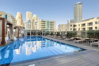 a large swimming pool on the roof of a building at GuestReady - Lux nest near JBR beach in Dubai