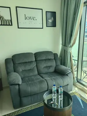 a living room with a couch and two water bottles on a table at 7 palm jumeirah West Beach in Dubai