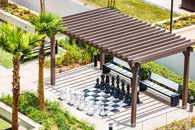 a chess board and a chess boardgame on a chess board at Daniels Poolside Studio in Meydan in Dubai