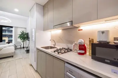 a kitchen with a sink and a counter top at Daniels Poolside Studio in Meydan in Dubai