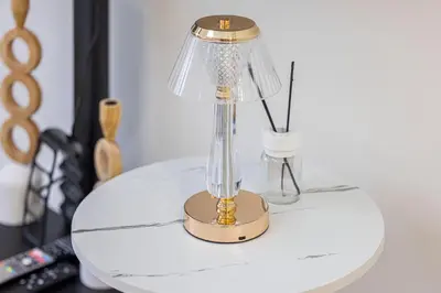a table with a lamp on top of it at Daniels Poolside Studio in Meydan in Dubai