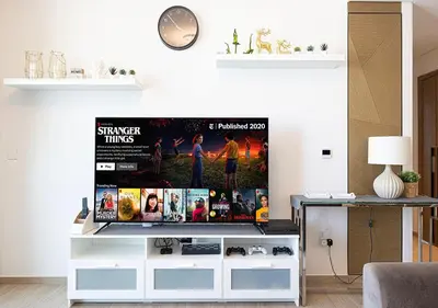 a living room with a tv on a entertainment center at Palace Residences 2BR with Stunning Creek Views in Dubai