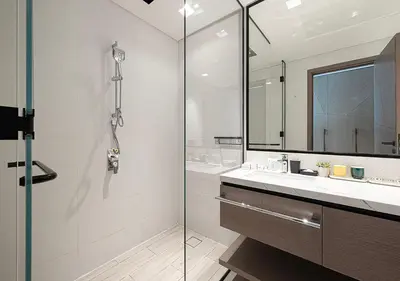 a bathroom with a glass shower and a sink at Palace Residences 2BR with Stunning Creek Views in Dubai
