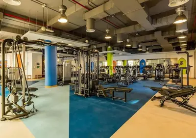 a gym with several treadmills and exercise equipment at Aesthetic Beach Apartment , Sleeps 6, Pool, Gym & Waterfront Views in Dubai