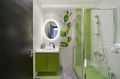 a bathroom with a sink and a shower at Stellar 2BR on Palm Jumeirah - Beach and Pool access in Dubai