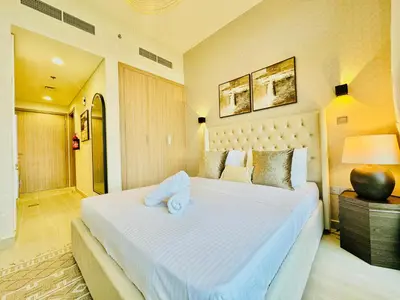 a bedroom with a large white bed in a room at Venduras - Modern Chic Studio in Azizi Riviera in Dubai