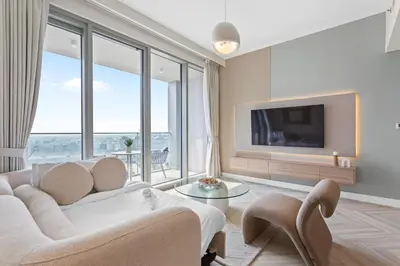 a living room with a couch and a tv at Luxurious Living in a 2 Bedroom at Forte Downtown in Dubai