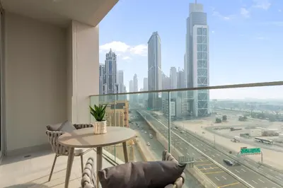 a room with a table and chairs and a large window at Luxurious Living in a 2 Bedroom at Forte Downtown in Dubai