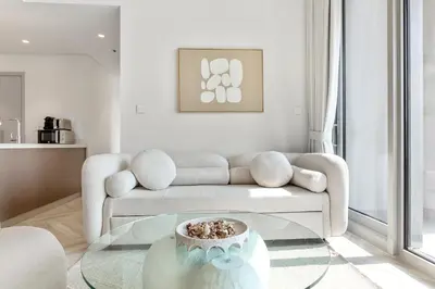 a living room with a couch and a glass table at Luxurious Living in a 2 Bedroom at Forte Downtown in Dubai