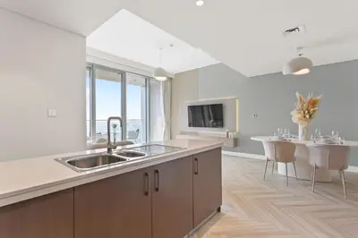 a large kitchen with a sink and a table at Luxurious Living in a 2 Bedroom at Forte Downtown in Dubai