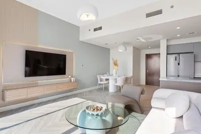 a living room with a couch and a tv at Luxurious Living in a 2 Bedroom at Forte Downtown in Dubai
