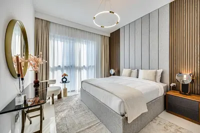 a bedroom with a large bed and a mirror at Stunning 2 Bedroom in Emaar Beachfront in Dubai