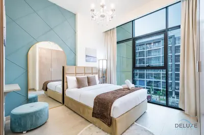 a bedroom with a bed and a large window at Charming 1BR Apartment in Azizi Riviera 30, Al Merkadh by Deluxe Holiday Homes in Dubai