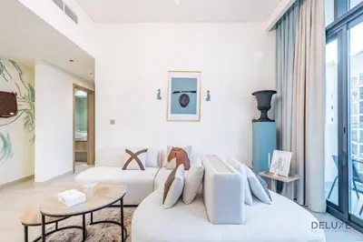 a living room with two white couches and a table at Charming 1BR Apartment in Azizi Riviera 30, Al Merkadh by Deluxe Holiday Homes in Dubai
