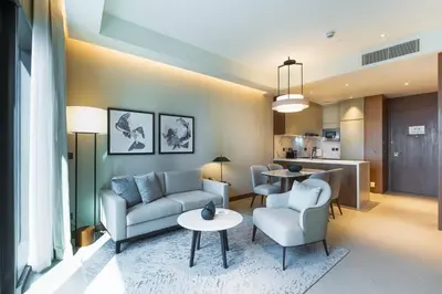 a living room with a couch and chairs and a table at Deluxe Address Opera Home with Full Sea View in Dubai