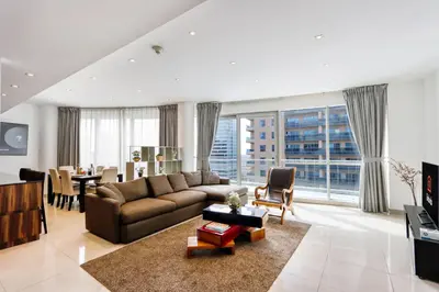a large living room with a couch and a table at Livbnb - Contemporary Suite with Private Plunge Pool in Dubai
