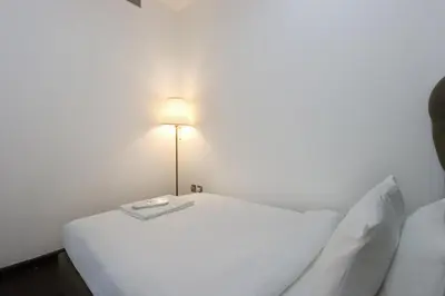a room with two beds and a light on the wall at Livbnb - Contemporary Suite with Private Plunge Pool in Dubai