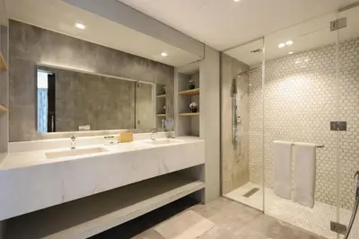 a bathroom with two sinks and a shower at Livbnb - Contemporary Suite with Private Plunge Pool in Dubai