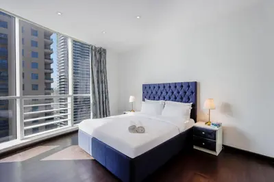 a bedroom with a large bed and a large window at Livbnb - Contemporary Suite with Private Plunge Pool in Dubai