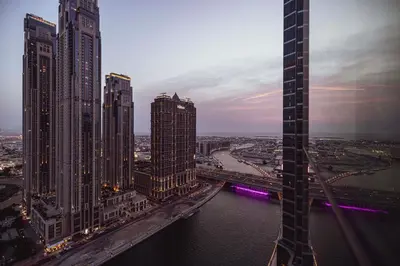 a view of a city with tall buildings and a river at Luxurious 1BR in Court Tower Business Bay in Dubai