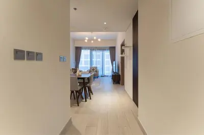 a hallway with a dining room and a living room at HAVN - 1 Bedroom Unit in Azizi Riviera, Meydan in Dubai