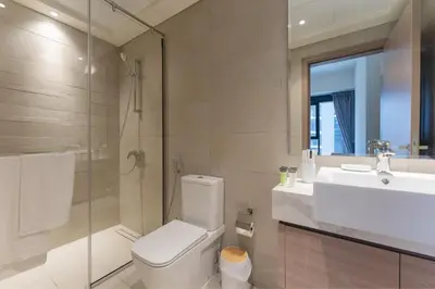 a bathroom with a toilet and a sink and a shower at HAVN - 1 Bedroom Unit in Azizi Riviera, Meydan in Dubai