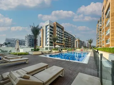 a swimming pool with chaise lounges and a resort at HAVN - 1 Bedroom Apartment in Azizi Riviera in Dubai