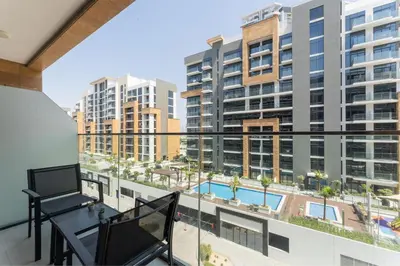a balcony with a view of a pool and buildings at HAVN - 1 Bedroom Apartment in Azizi Riviera in Dubai