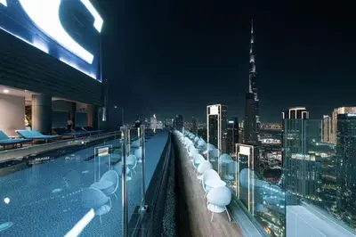 a rooftop swimming pool with a view of a city at Stunning Burj Views - Highest Infiniti Pool in Dubai