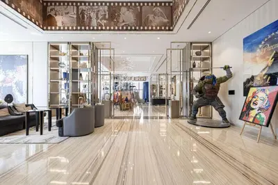 a room with a statue of a man on a snowboard at Stunning Burj Views - Highest Infiniti Pool in Dubai