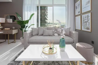 a living room with a couch and a table at Sunrise Bay Tower 2 - Beachfront Spectacular Two Bedroom with Private Beach Access in Dubai