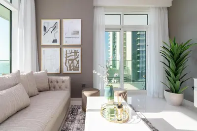 a living room with a couch and a table at Sunrise Bay Tower 2 - Beachfront Spectacular Two Bedroom with Private Beach Access in Dubai