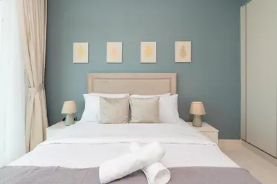 a bedroom with a bed with white sheets and pillows at Sunrise Bay Tower 2 - Beachfront Spectacular Two Bedroom with Private Beach Access in Dubai