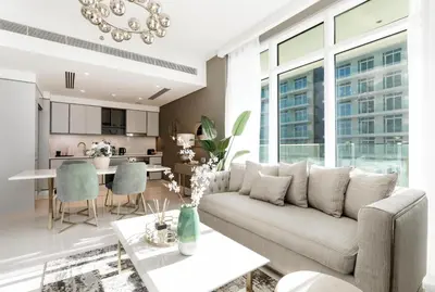 a living room with a couch and a table at Sunrise Bay Tower 2 - Beachfront Spectacular Two Bedroom with Private Beach Access in Dubai