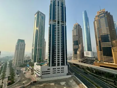 a group of tall buildings in a city at Modern 1BR with Balcony, Pool and Gym, Dubai Marina in Dubai