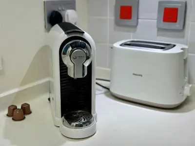 a hair dryer sitting on a counter next to a toaster at Modern 1BR with Balcony, Pool and Gym, Dubai Marina in Dubai