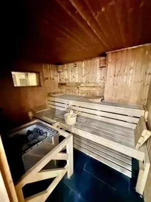 a sauna with wooden walls and a wooden floor at Modern 1BR with Balcony, Pool and Gym, Dubai Marina in Dubai
