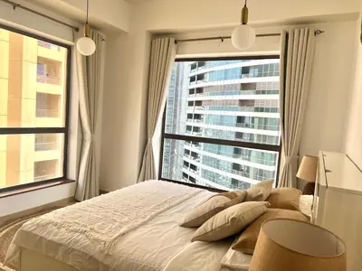 a bedroom with a bed and a large window at High Floor 1BR Apartment with breathtaking sea views of AIN Dubai in Dubai