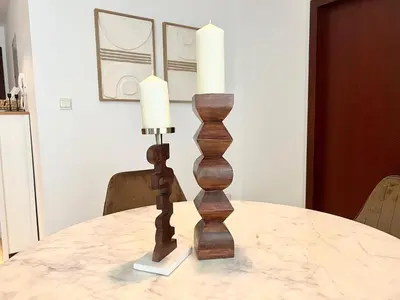 a candle holder on a table with two candles at High Floor 1BR Apartment with breathtaking sea views of AIN Dubai in Dubai
