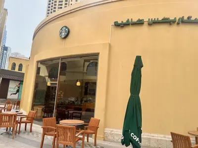 a closed umbrella sitting outside of a restaurant at High Floor 1BR Apartment with breathtaking sea views of AIN Dubai in Dubai