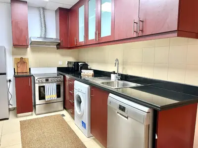 a kitchen with a sink and a dishwasher at High Floor 1BR Apartment with breathtaking sea views of AIN Dubai in Dubai