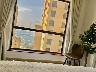 a bedroom with a window with a view of a city at High Floor 1BR Apartment with breathtaking sea views of AIN Dubai in Dubai