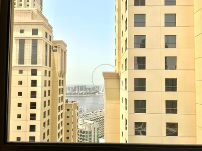 a view from a window of some tall buildings at High Floor 1BR Apartment with breathtaking sea views of AIN Dubai in Dubai