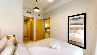 a white bedroom with a bed with towels on it at Vacationer I Elegant 2 Bedroom I Business Bay I Central & Convenient I Aykon City Tower in Dubai
