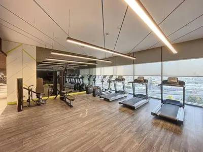 a gym with a row of treadmills and machines at Vacationer I Elegant 2 Bedroom I Business Bay I Central & Convenient I Aykon City Tower in Dubai