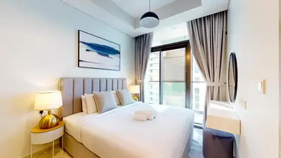 a bedroom with a white bed and a large window at Vacationer I Elegant 2 Bedroom I Business Bay I Central & Convenient I Aykon City Tower in Dubai