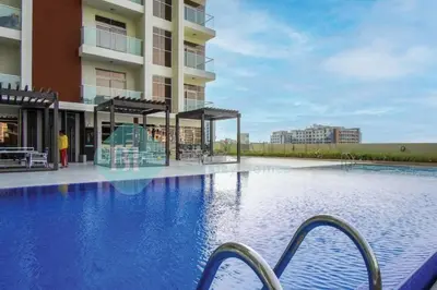 a large swimming pool in front of a building at Bloomfields Hidden Gem Studio In Arjan in Dubai